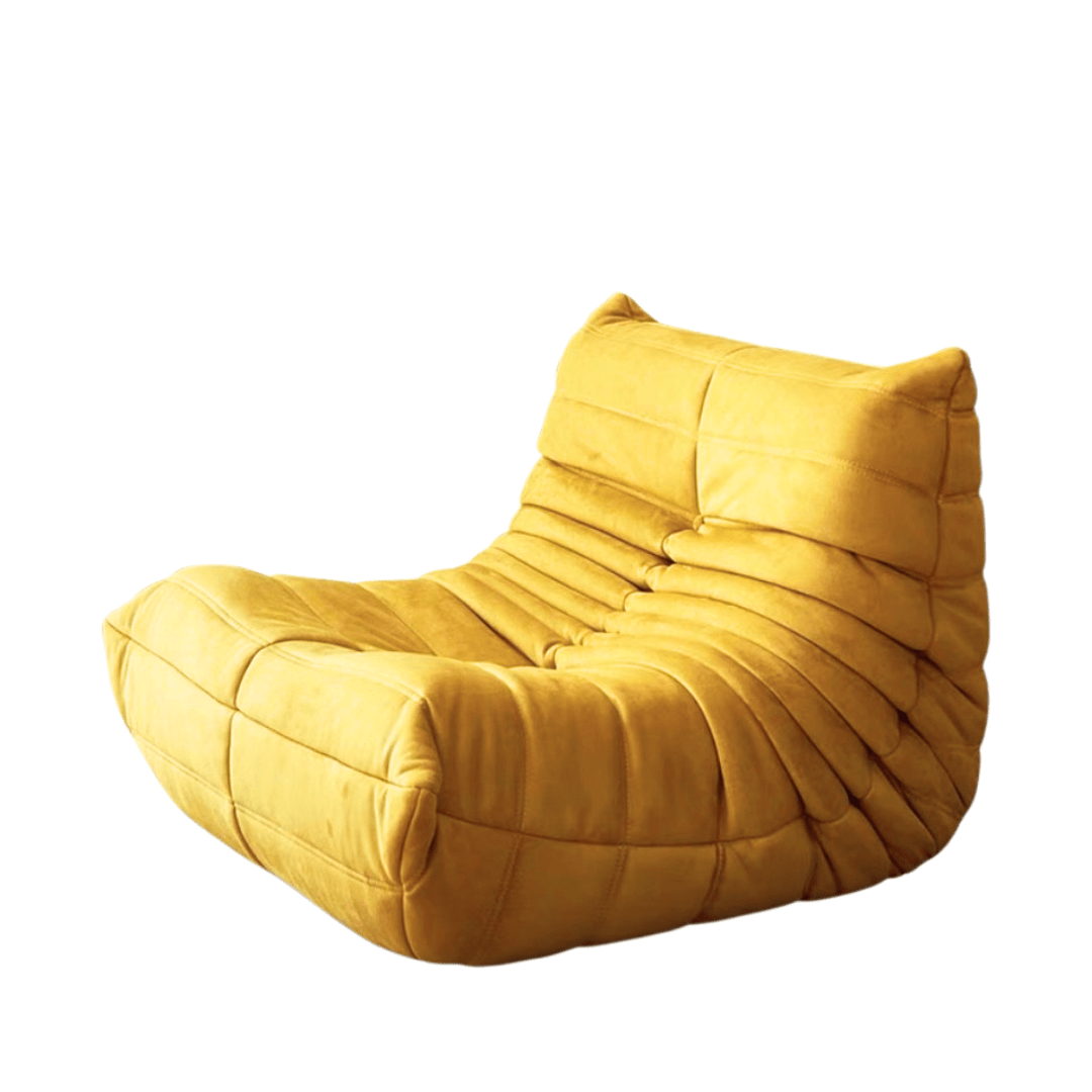 The Chillax Lounger Sofa Chair features yellow tufted upholstery, an ergonomic curved seat and backrest, and a modern low-profile design, shown on a white background.